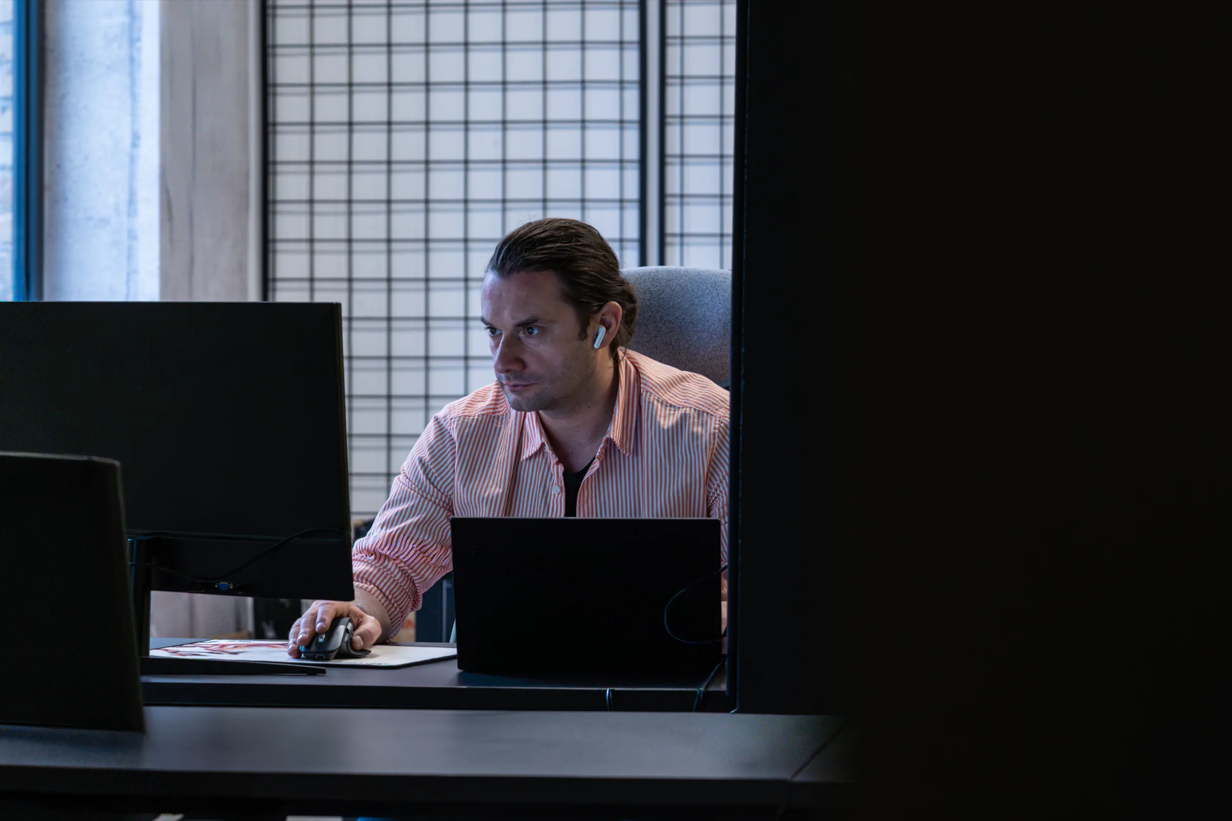 Nermin Šehić at his desk in the BetaStudio office, late night.